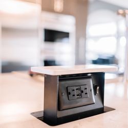 Wiles Design Group - This kitchen features bold cabinets, luxe lighting, and sleek countertops - stylish focal points visible from every part of the house.