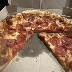 Domino's Pizza - New York style pizza with extra pepperoni and cheese?? I would not consider this extra cheese. I have no idea about the pepperoni.