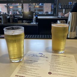 two glasses of beer on a table two glasses of beer on a table