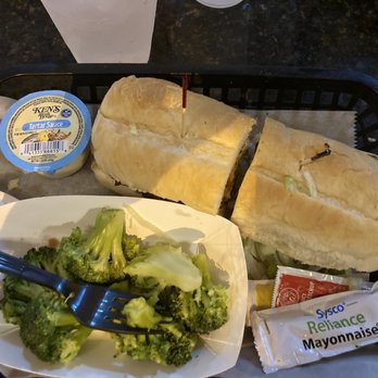 Rick's On the River - Famous fish sandwich with side of steamed broccoli - New American Near Me - Tampa, Florida Rick's On the River - Famous fish sandwich with side of steamed broccoli - New American Near Me - Tampa, Florida