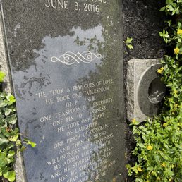 His grave nestled in lush landscaping