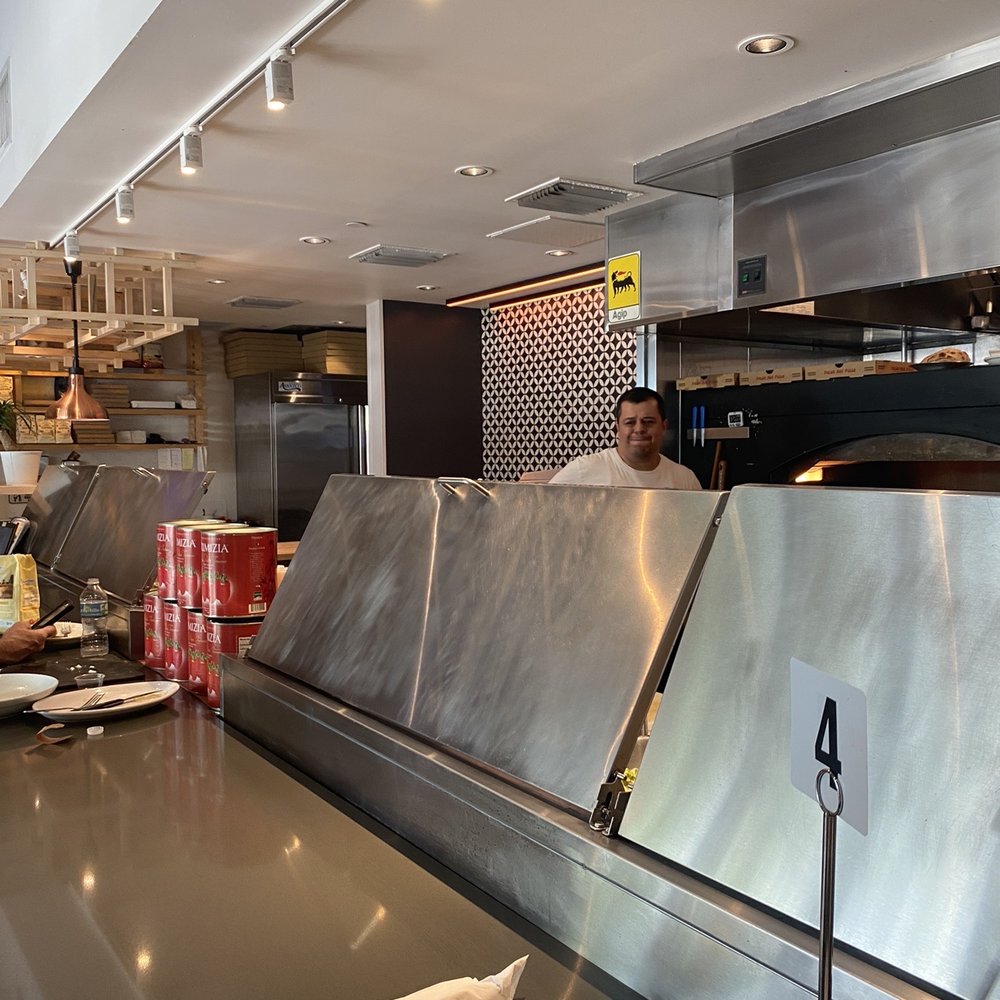 Cotto Pizza - a chef behind the counter - Pizza Near Me - Doral, Florida Cotto Pizza - a chef behind the counter - Pizza Near Me - Doral, Florida