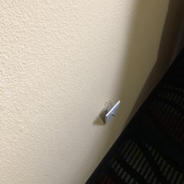 One of the three outlets pulled away from the wall.