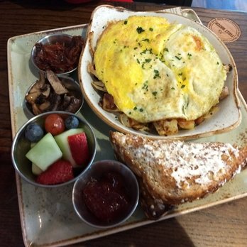 First Watch - Parma Hash w/overhard eggs. Fire roasted tomatoes and crimini mushrooms are on side. Served w/fruit salad, whole grain toast and preserves - Breakfast & Brunch Near Me - Columbia, Maryland