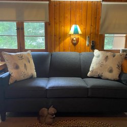 Golden-Fowler Home Furnishings - Navy blue sofa in log cabin