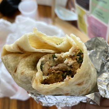 Mezeh Mediterranean Grill - a hand holding a burrito - Mediterranean Near Me - Charlotte, North Carolina Mezeh Mediterranean Grill - a hand holding a burrito - Mediterranean Near Me - Charlotte, North Carolina