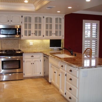 Elements - a kitchen with white cabinets and granite countertops - Interior Design Near Me - Tulare, California