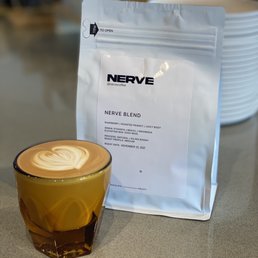 a bag of nerve next to a cup of coffee