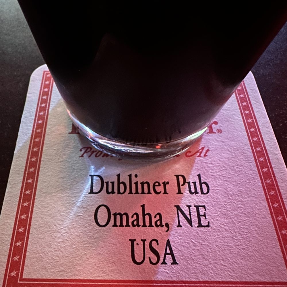 Dubliner Pub - Glass of Guinness on a coaster. The coaster has the words Dubliner Pub, Omaha, NE - Pubs Near Me - Omaha, Nebraska Dubliner Pub - Glass of Guinness on a coaster. The coaster has the words Dubliner Pub, Omaha, NE - Pubs Near Me - Omaha, Nebraska