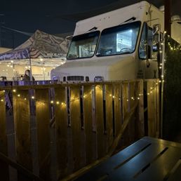 Food truck conveniently parked next to the main seating area Food truck conveniently parked next to the main seating area
