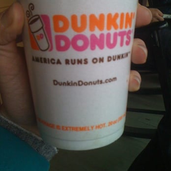 Dunkin' - a person holding a cup of coffee - Donuts Near Me - North Adams, Massachusetts Dunkin' - a person holding a cup of coffee - Donuts Near Me - North Adams, Massachusetts