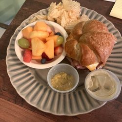 Sweet Azalea Gourmet Shop & Catering - The club on croissant  with a side of chips and fresh fruit