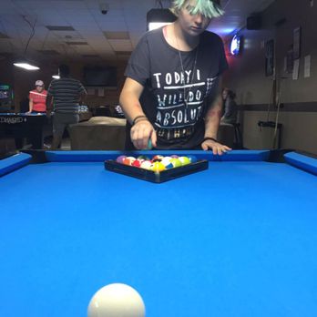 Skinny Bob's Billiards - a man playing pool - Pool Halls Near Me - Round Rock, Texas