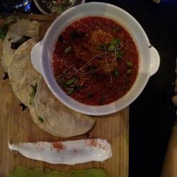 Tapageur - Rabbit stew served with soft tortillas on a cutting board for DIY tacos