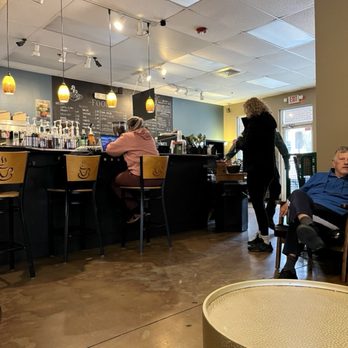Mugs Coffee - people sitting at tables in a coffee shop - Coffee & Tea Near Me - Charlotte, North Carolina