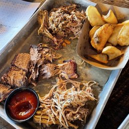 A tray of meat! Pulled chicken, pulled pork, beef brisket, and a small order of fries