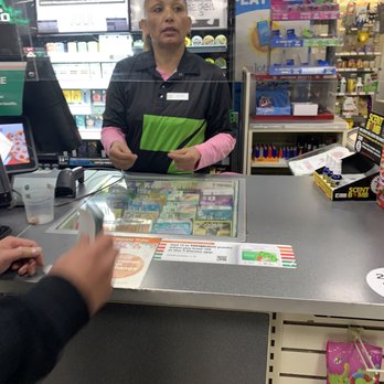 7-Eleven - a woman at a cash register - Convenience Stores Near Me - San Jose, California