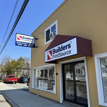 Builders FirstSource - Street‑level exterior of a Builders FirstSource building materials store featuring a yellow facade, front glass entrance, bra... - Building Supplies Near Me - Salem, Massachusetts