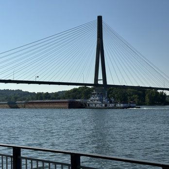 Schooner's Waterfront Grille - View of a barge going down the river - American Near Me - Huntington, West Virginia Schooner's Waterfront Grille - View of a barge going down the river - American Near Me - Huntington, West Virginia