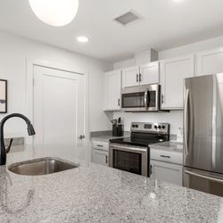 Bonacio Management - Stainless steel appliances and solid surface countertops are featured in the kitchens of Air City Lofts