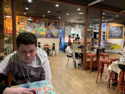 Photo of La Taquiza Taqueria Centro  - Lexington, KY, US.  young man sitting at a table in a restaurant