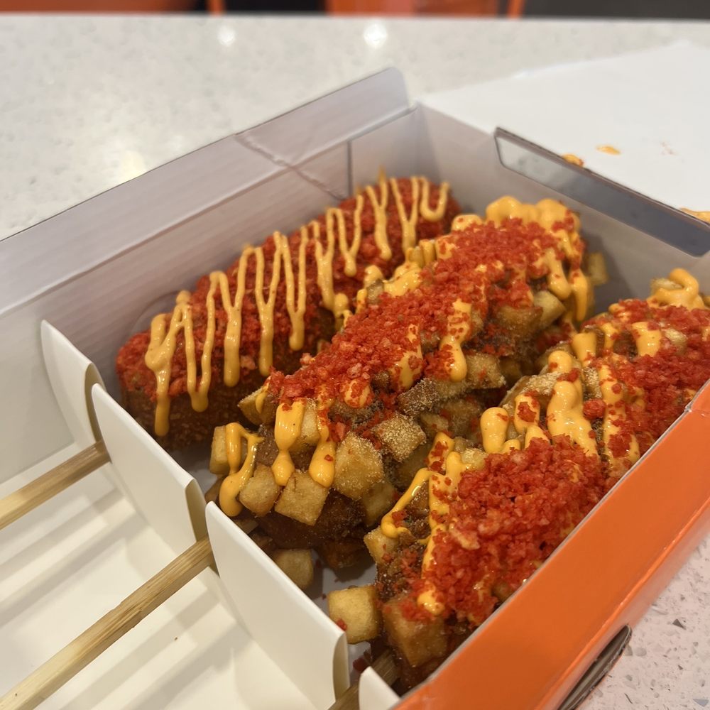 Two Hands Corn Dogs - Spicy Dog (left) and Potato Dog (middle/right) - Korean Near Me - Torrance, California Two Hands Corn Dogs - Spicy Dog (left) and Potato Dog (middle/right) - Korean Near Me - Torrance, California