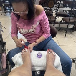 Tania at work on my toe color. Tania at work on my toe color.