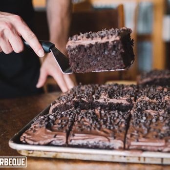 City Barbeque - a person cutting a chocolate cake - Barbeque Near Me - Winston-Salem, North Carolina City Barbeque - a person cutting a chocolate cake - Barbeque Near Me - Winston-Salem, North Carolina