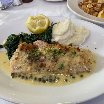 Hemmingway's Bistro - White fish with capers and lemon butter sauce, and a traditional breakfast in the background - Breakfast & Brunch Near Me - Oak Park, Illinois