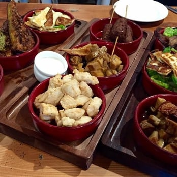 Mylk Bar - Our tapas selection- haloumi, dolmades, corn & zucchini fritters, lamb koftas, popcorn chicken, crispy pancetta, pork belly. - Bars Near Me - Adelaide, SA