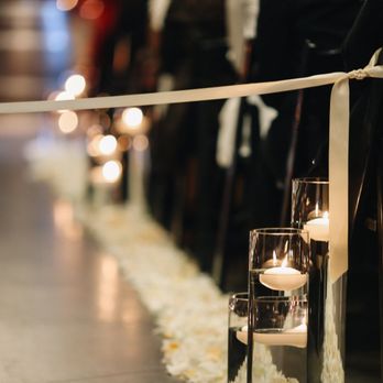 Delford West Flowers - Floating candles and rose petals down the aisle. Floating candles were repurposed as centerpieces - Florists Near Me