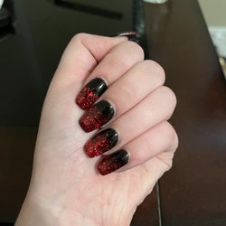 My nails, coffin nails with black dip powder and red glitter tips.