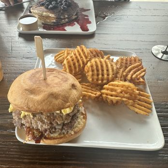 Breakfast - Breakfast hamburger with hamburger sausage egg hashbrowns cheese and bacon jam. And the waffle fries are perfectly crispy. - Breakfast & Brunch Near Me - New Braunfels, Texas
