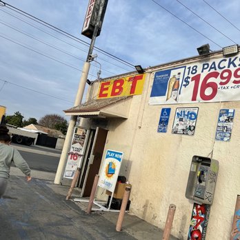 El Rinconcito - a woman walking past a business - Mexican Near Me - Carson, California