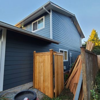 ESG Construction - a blue house with a wood fence - General Contractors Near Me ESG Construction - a blue house with a wood fence - General Contractors Near Me