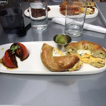 Proper Bagel - Scrambled egg and ricotta breakfast sandwich with a side of roasted tomato and avocado. - Bagels Near Me - Nashville, Tennessee Proper Bagel - Scrambled egg and ricotta breakfast sandwich with a side of roasted tomato and avocado. - Bagels Near Me - Nashville, Tennessee