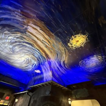 Van Gogh Cafe - The ceiling features a mural resembling Van Gogh's 'Starry Night,' with swirling patterns in blue, yellow, and white, illuminated by blue lighting. - Cafes Near Me - Hamilton, New Jersey