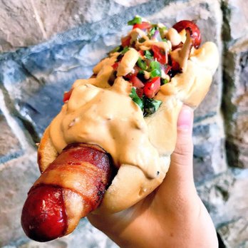 Jake Melnick's Corner Tap - Bacon-wrapped hot link with chipotle crema and pico de gallo - Sports Bars Near Me - Chicago, Illinois Jake Melnick's Corner Tap - Bacon-wrapped hot link with chipotle crema and pico de gallo - Sports Bars Near Me - Chicago, Illinois