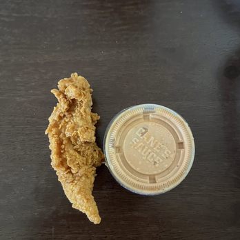 Raising Cane's Chicken Fingers - Chicken finger comparison to small sauce cup. - Fast Food Near Me - Imperial Beach, California Raising Cane's Chicken Fingers - Chicken finger comparison to small sauce cup. - Fast Food Near Me - Imperial Beach, California