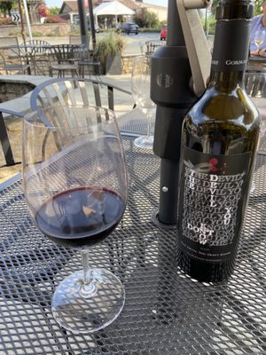 Photo of Gorman Winery Hollywood Hills Tasting Room - Woodinville, WA, US. a glass of wine and a bottle of wine