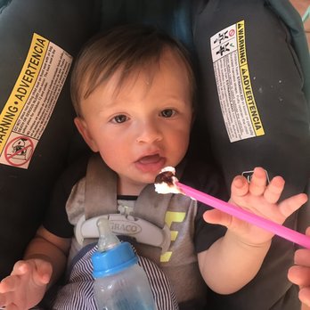 Tedi's Olde Tyme Ice Cream - Happy baby eating mommas whip cream with chocolate syrup - Ice Cream & Frozen Yogurt Near Me - St. Augustine, Florida