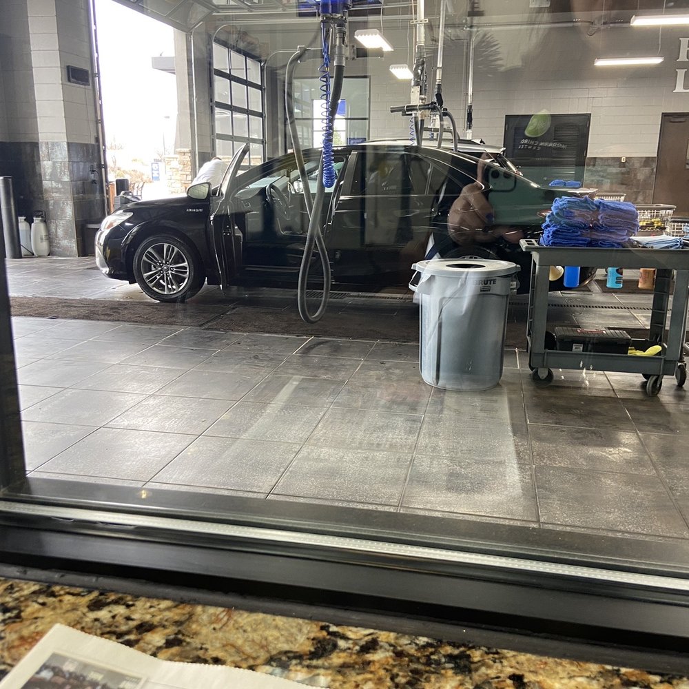 Waiting inside the waiting room looking at my car being cleaned Waiting inside the waiting room looking at my car being cleaned