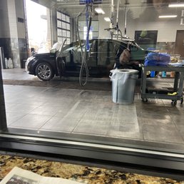 Waiting inside the waiting room looking at my car being cleaned Waiting inside the waiting room looking at my car being cleaned