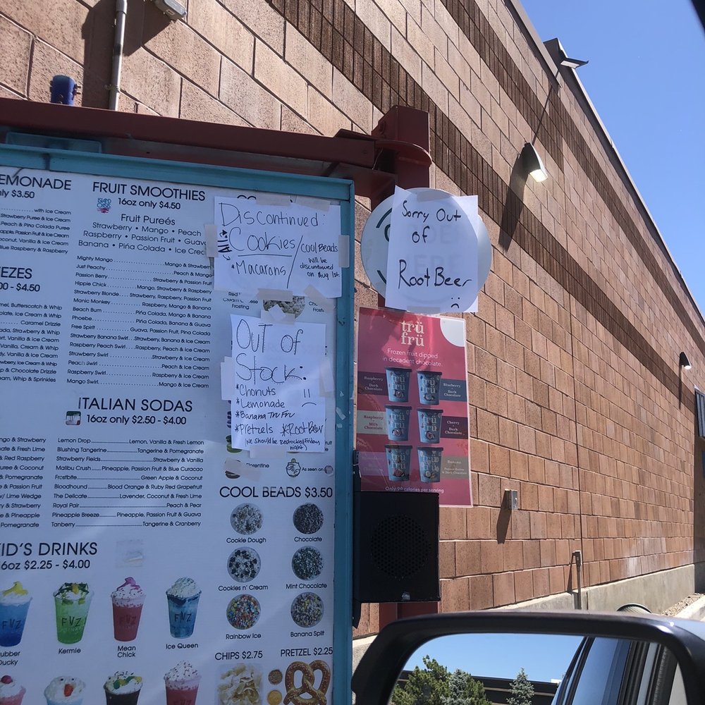 a menu on a sign in front of a building a menu on a sign in front of a building