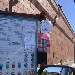 a menu on a sign in front of a building a menu on a sign in front of a building