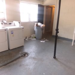 Orange Property Management - Communal laundry full of trash, looked like someone was also living in here. Was like this for over a month.