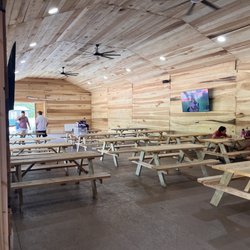 Log Home Brewing - Covered outdoor area with fans and TVs