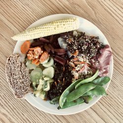 The Hub - Quinoa tabouli, cucumber salad, red Swiss chard, snow peas, cole slaw, kale salad, hummus, sautéed carrots, mini corn, whole grain sourdough