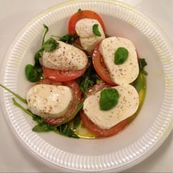 Caprese salad with the teenist tiniest basil leaves I've ever seen.