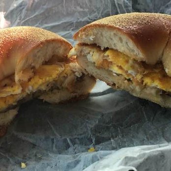 Bagels Plus Deli - Sausage, egg & cheese on a plain bagel, at Bagels Plus Deli in Canton, CT. - A bagel sandwich filled with scrambled eggs and cheese, cut in half, placed on crinkled paper. - Bagels Near Me - Canton, Connecticut